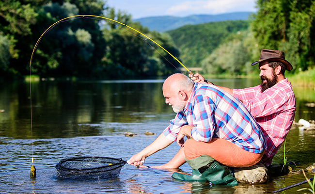 man with fishing net in river