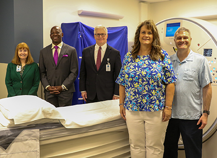 Donors  and staff in front of new CT scanner