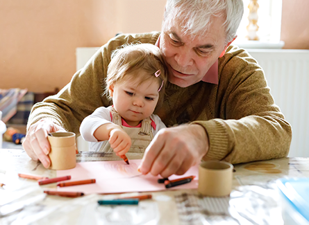 Grandpa with young granddaughter coloring