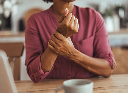 Woman holding wrist