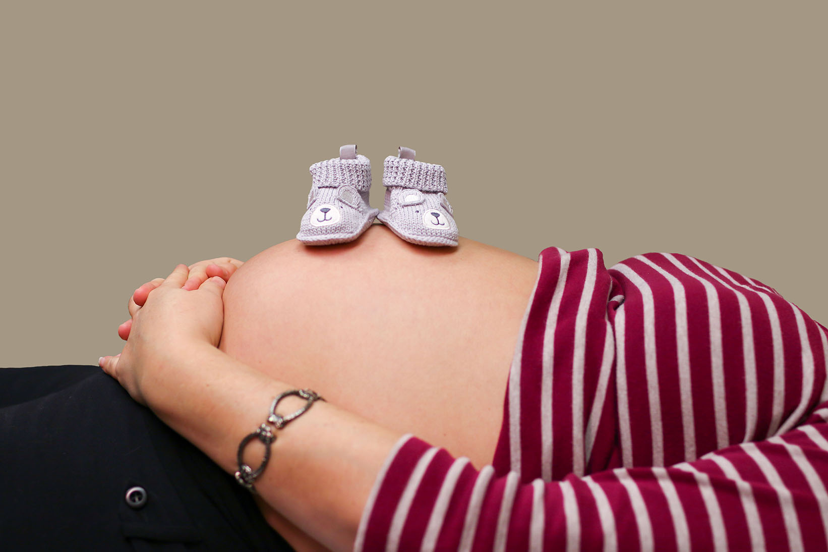 baby booties on pregnant belly