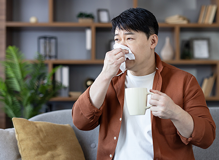 Man blowing nose
