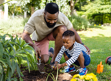 Man gardening with his young son