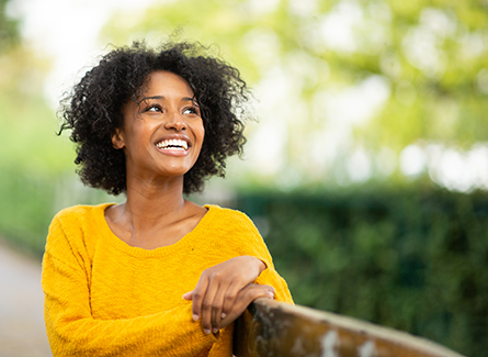 Woman in park wearing yellow shirt