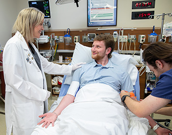 Pharmacist with patient in ER