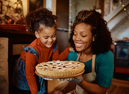 Mother and daughter baking holiday pie